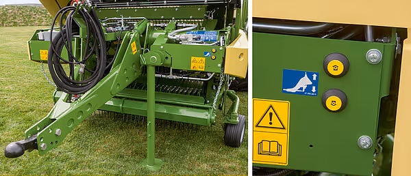 Detalj av styrespak og kontrollpanel på grønn landbruksmaskin med varselmerking og styringselementer.