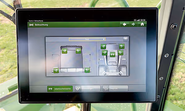 Touchscreen-display som viser belysningskontroll med grønt grensesnitt og ulike lampeinnstillinger for slåtteutstyret.