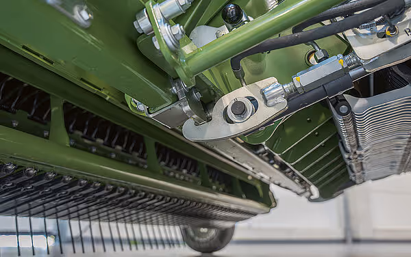 Detaljbilde av understellet på en grønn KRONE Big Pack HDP II storballpresse, som viser hydrauliske komponenter og drivverk.