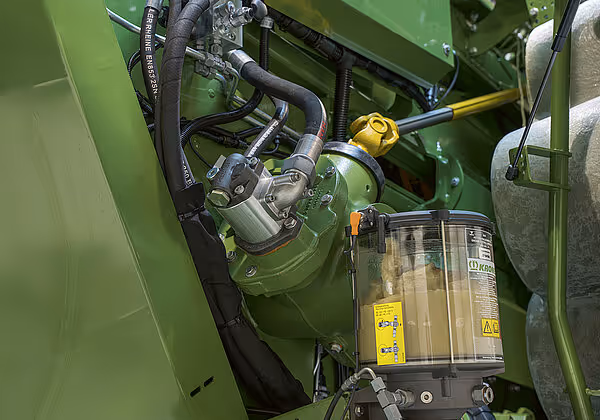 Detaljbilde av hydrauliske komponenter og slanger inne i en grønn KRONE Big Pack HDP II rundballpresse.