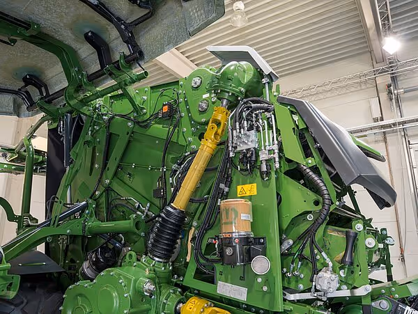 KRONE CombiPack HDP ballepress med hydrauliske komponenter og gule drivaksler synlige i maskinrommet.