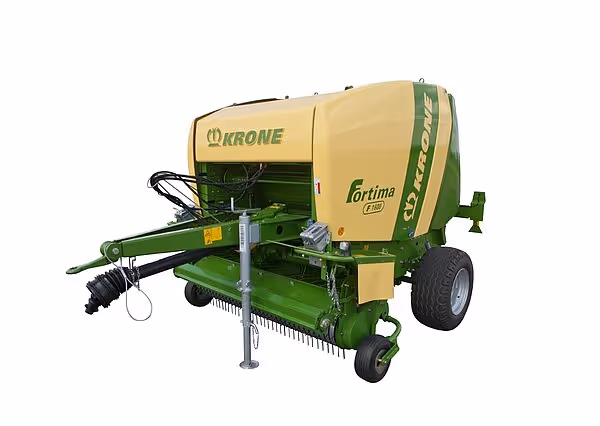 KRONE Fortima rundballpresse vist fra siden mot hvit bakgrunn. Maskinen har karakteristisk grønn og gul fargekombinasjon med synlig oppsamlingssystem.