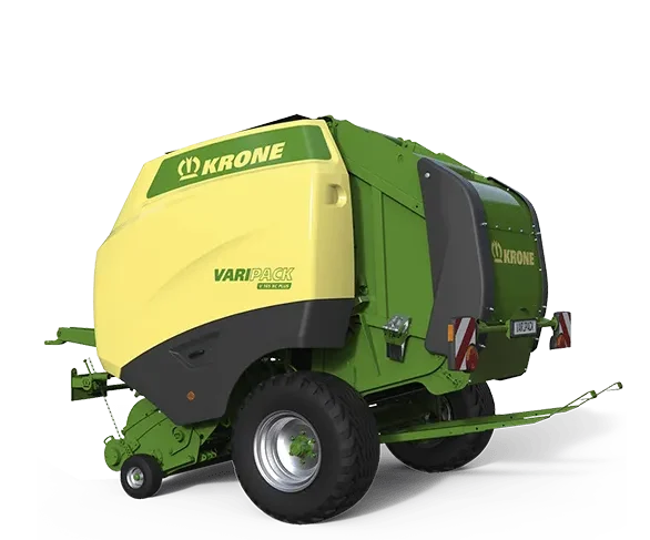 Krone Varipack Plus rundballpresse i grønn og gul farge vist mot sort bakgrunn.