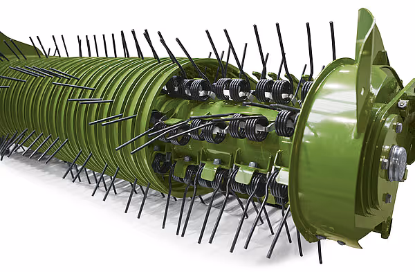 Detaljbilde av roterende høstelement på KRONE ZX med tinder og interne mekanismer som samler og transporterer høyet.